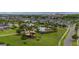 Expansive aerial view of a community featuring homes, mature trees, and a community pool and playground at 4952 Creekside Park Ave, Orlando, FL 32811