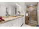 Bathroom featuring double sinks, granite countertops, and a glass-enclosed shower at 4952 Creekside Park Ave, Orlando, FL 32811
