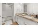 Bathroom featuring double sinks with granite countertops and a glass shower at 4952 Creekside Park Ave, Orlando, FL 32811