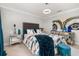 Bedroom with blue curtains, unique bedspread, and mirrored accents at 4952 Creekside Park Ave, Orlando, FL 32811