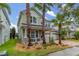Charming two-story home with a porch framed by palm trees at 4952 Creekside Park Ave, Orlando, FL 32811