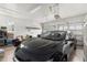 Clean, well-lit two-car garage with a dark sedan and ample storage space at 4952 Creekside Park Ave, Orlando, FL 32811