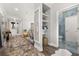 Inviting hallway with hardwood floors, stylish decor, and a glimpse into the luxurious bathroom at 4952 Creekside Park Ave, Orlando, FL 32811