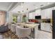 Elegant kitchen featuring a large island with bar seating, pendant lighting, and modern appliances at 4952 Creekside Park Ave, Orlando, FL 32811