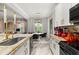 Bright, open kitchen with a large island, modern appliances, and a dining area with backyard views at 4952 Creekside Park Ave, Orlando, FL 32811