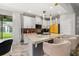Modern kitchen with an island, bar seating, stainless steel appliances, and sleek white cabinetry at 4952 Creekside Park Ave, Orlando, FL 32811