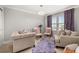 Cozy living room with plush seating, a modern chandelier, and large windows at 4952 Creekside Park Ave, Orlando, FL 32811