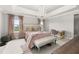 Luxurious bedroom with a chandelier, plush bedding, and a dedicated workspace, offering comfort and style at 4952 Creekside Park Ave, Orlando, FL 32811
