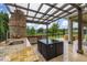 Spacious outdoor kitchen with granite countertops, a sink, and a view of the peaceful lake at 4952 Creekside Park Ave, Orlando, FL 32811