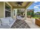 Covered patio featuring comfortable seating, hanging chair, and an outdoor kitchen area at 4952 Creekside Park Ave, Orlando, FL 32811