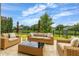 Outdoor patio featuring stylish wicker furniture and a serene waterfront view at 4952 Creekside Park Ave, Orlando, FL 32811
