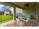 Outdoor patio with dining set and colorful rug, perfect for entertaining at 4952 Creekside Park Ave, Orlando, FL 32811