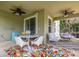 Outdoor patio with dining set, egg chair, and colorful rug at 4952 Creekside Park Ave, Orlando, FL 32811
