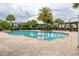 Community pool with brick patio, palm trees, pergola seating, and convenient shower, perfect for outdoor enjoyment at 4952 Creekside Park Ave, Orlando, FL 32811