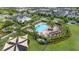 Aerial view showcasing the community pool, playground, and clubhouse surrounded by well-maintained lawns and palm trees at 4952 Creekside Park Ave, Orlando, FL 32811