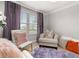 Cozy sitting area featuring stylish chairs and decorative pillows near bright windows at 4952 Creekside Park Ave, Orlando, FL 32811
