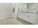 Bathroom with wood-look tile floor, double vanity, and neutral walls at 515 Everest Way, Kissimmee, FL 34758