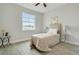 Bedroom with wood-look tile floor, neutral walls, ceiling fan, and natural light at 515 Everest Way, Kissimmee, FL 34758
