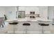 Modern kitchen featuring a large center island with granite countertops, seating, and stainless steel appliances at 515 Everest Way, Kissimmee, FL 34758
