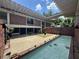 Brick home featuring a courtyard with a pool and a small garden at 550 Lake Otis Se Dr, Winter Haven, FL 33880