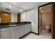 Bathroom featuring hexagon tile, granite countertops, and glass shower at 550 Lake Otis Se Dr, Winter Haven, FL 33880