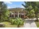 Modern brick home with an expansive covered entrance, lush landscaping and a charming walkway at 550 Lake Otis Se Dr, Winter Haven, FL 33880