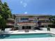 Multi-story building featuring a pool and multiple balconies overlooking the waterfront at 550 Lake Otis Se Dr, Winter Haven, FL 33880