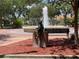 Community fountain adorned with a seated statue of a reading a book, surrounded by lush greenery at 550 Lake Otis Se Dr, Winter Haven, FL 33880