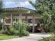 Beautifully landscaped front exterior with mature palms and unique architectural details at 550 Lake Otis Se Dr, Winter Haven, FL 33880