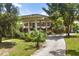 Lush greenery surrounds the home, highlighting its architectural style and features at 550 Lake Otis Se Dr, Winter Haven, FL 33880