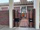 Front gated entrance with brick lined walkway leading to door of brick home at 550 Lake Otis Se Dr, Winter Haven, FL 33880