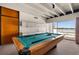 Game room with a pool table, wet bar, and a view of the pool and waterfront at 550 Lake Otis Se Dr, Winter Haven, FL 33880