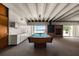 Game room featuring a pool table, wet bar, fireplace, and water views at 550 Lake Otis Se Dr, Winter Haven, FL 33880