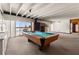 Game room featuring a pool table, wet bar, and access to the pool and lake views at 550 Lake Otis Se Dr, Winter Haven, FL 33880