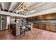 Spacious kitchen features a center island, stainless steel refrigerator, and brick paver floors at 550 Lake Otis Se Dr, Winter Haven, FL 33880