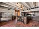 Open kitchen with brick paver flooring, stainless steel refrigerator, and bar stool seating at the island at 550 Lake Otis Se Dr, Winter Haven, FL 33880