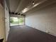 Bright living room with sliding glass doors offering a serene view of the backyard at 550 Lake Otis Se Dr, Winter Haven, FL 33880