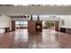 Bright living area featuring a fireplace, brick flooring, and water views at 550 Lake Otis Se Dr, Winter Haven, FL 33880