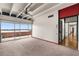 Open living room with ceiling fan and sliding glass doors offering panoramic water views at 550 Lake Otis Se Dr, Winter Haven, FL 33880