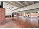 Bright living room with brick accent wall, brick floors and access to outdoor courtyard at 550 Lake Otis Se Dr, Winter Haven, FL 33880