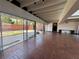 Bright living space featuring brick floors and expansive glass doors to the outdoors at 550 Lake Otis Se Dr, Winter Haven, FL 33880