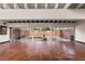 Open living space with brick floors, floor to ceiling glass doors and a courtyard view at 550 Lake Otis Se Dr, Winter Haven, FL 33880
