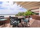 Relaxing outdoor patio features a table, seating and beautiful water view at 550 Lake Otis Se Dr, Winter Haven, FL 33880