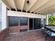 Outdoor patio with barbecue and seating area overlooking the water at 550 Lake Otis Se Dr, Winter Haven, FL 33880