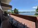 Expansive brick patio with seating offers stunning views of the adjacent lake at 550 Lake Otis Se Dr, Winter Haven, FL 33880