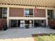 Exterior of home with expansive patio, brickwork, and large sliding glass doors at 550 Lake Otis Se Dr, Winter Haven, FL 33880