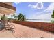 Brick patio with seating area offering beautiful water views on a sunny day at 550 Lake Otis Se Dr, Winter Haven, FL 33880