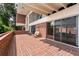 Spacious brick patio with large windows, sliding glass doors, and an outdoor swing at 550 Lake Otis Se Dr, Winter Haven, FL 33880