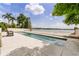Backyard pool with views of the lake, surrounded by a concrete deck at 550 Lake Otis Se Dr, Winter Haven, FL 33880