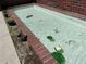 Small water feature with clean water, brick outline, and aquatic plants at 550 Lake Otis Se Dr, Winter Haven, FL 33880